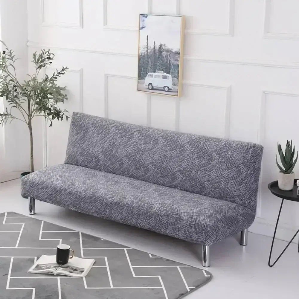 Gray textured fabric decorbites armless futon sofa cover with subtle geometric pattern snugly fitted over frame