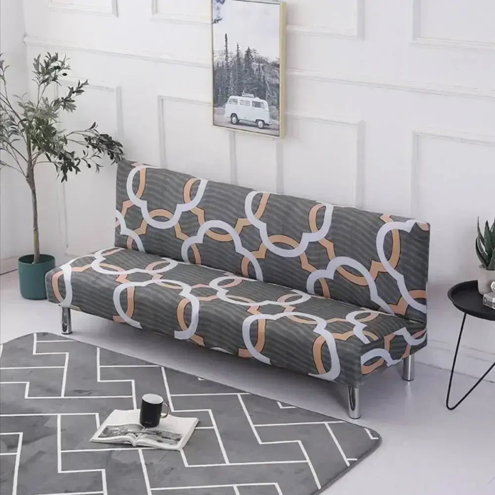 Gray decorbites armless futon sofa cover with elastic slipcover and geometric white copper ring pattern on textured fabric