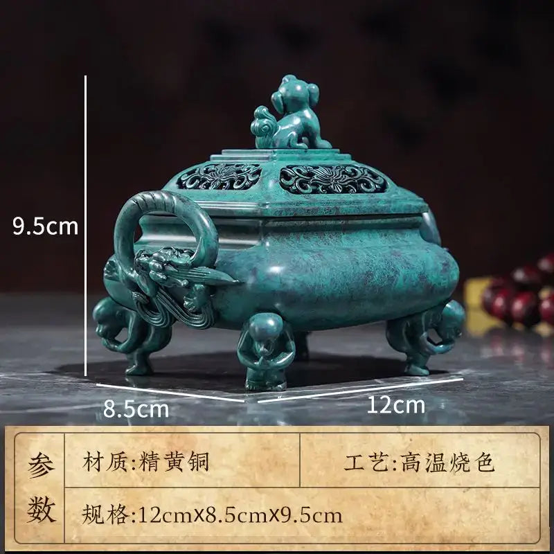A teal-green intricately carved decorbites aromatherapy brass incense stove with dragon handle and four animal feet for home decor