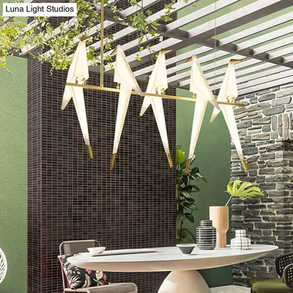 Modern white acrylic bird island pendant light with gold-toned metal accents featuring art deco design