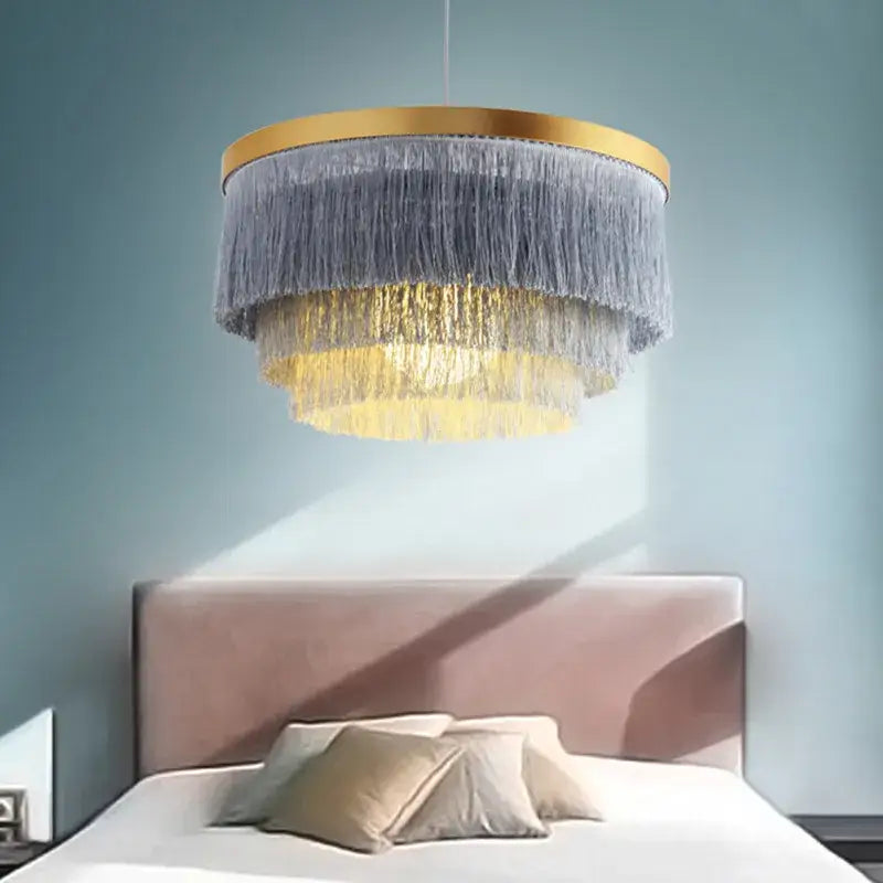 DecorBites Art Deco tiered chandelier with gold-toned frame and cascading gray and golden cotton thread fringes