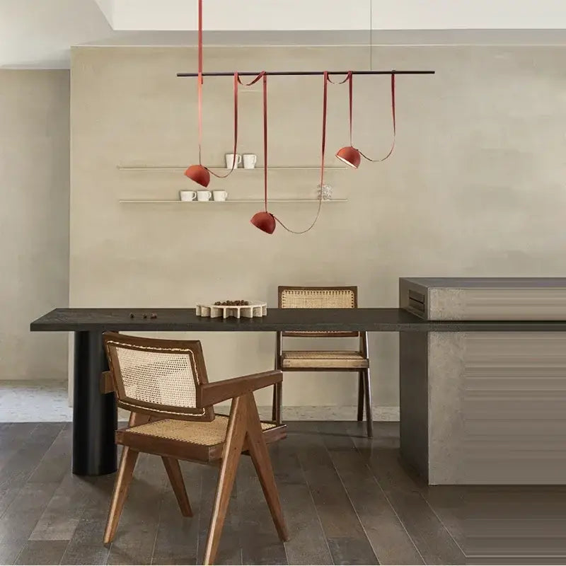 Decorbites™ art deco cross belt orange lustre hanging lamp with sleek red pendants above dining table
