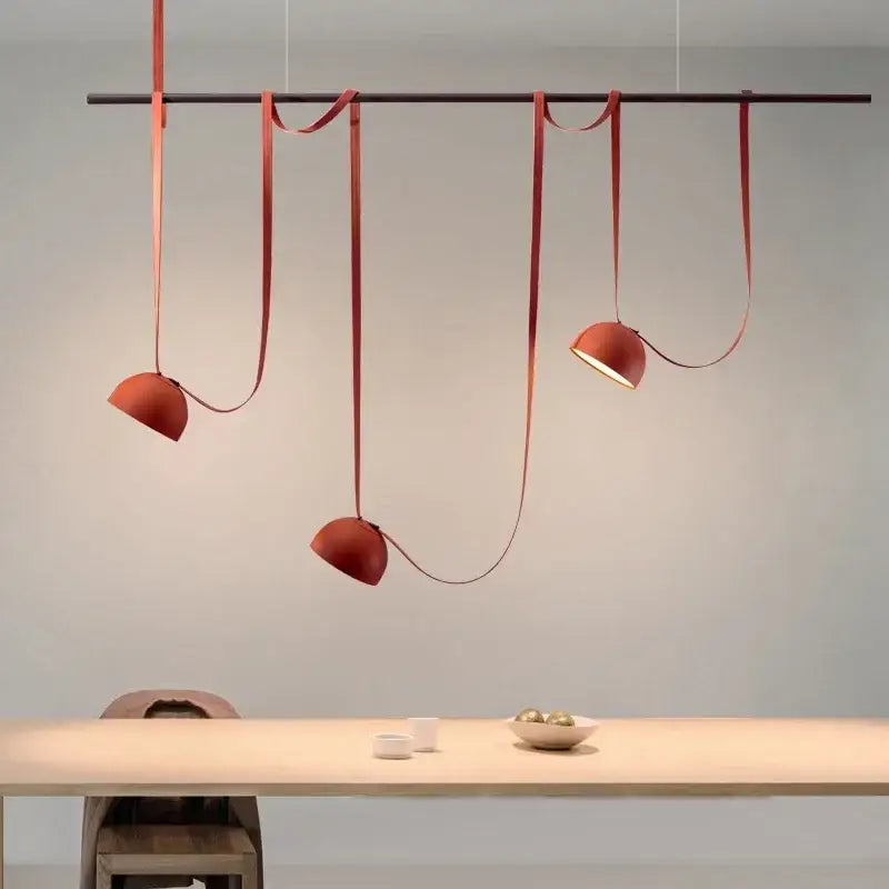 Modern red leather cross belt hanging lamp with orange lustre finish and minimalist design for living room decor