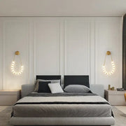 Modern gray upholstered bed with black textured headboard and decorbites led wall sconce in black gold lighting