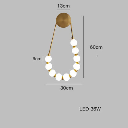 Gold-toned DecorBites™ Art Deco led wall sconce with seven white glass LED bulbs in a curved chain design