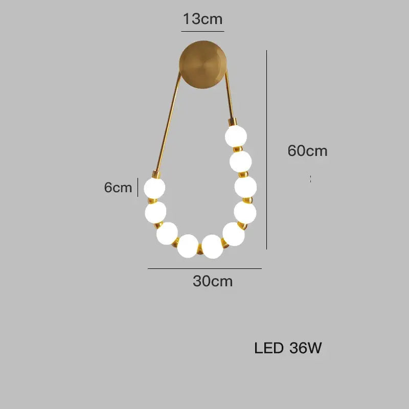 Gold-toned DecorBites™ Art Deco led wall sconce with seven white glass LED bulbs in a curved chain design