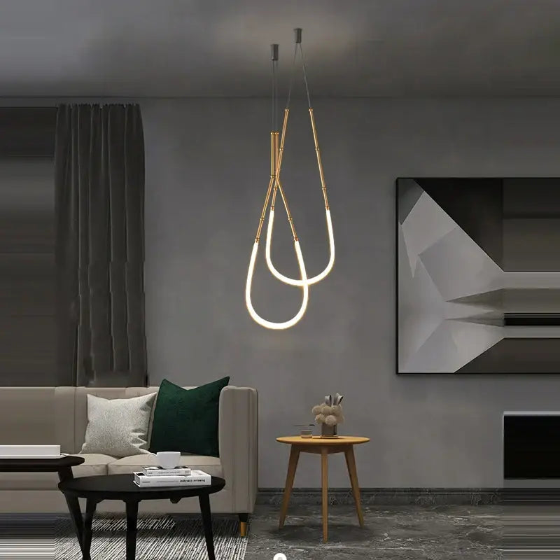 Modern gold-toned decorbites art deco pendant light with sleek vertical led tubes and minimalist metallic rods for dining room