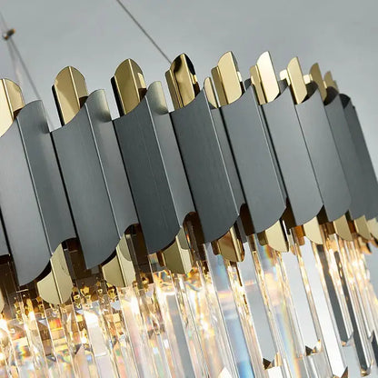 A decorbites art deco golden crystal chandelier featuring matte black and gold panels with hanging crystal prisms