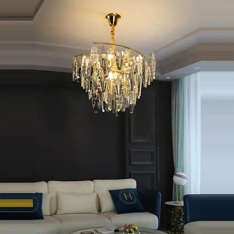 A luxurious gold-toned decorbites art deco led crystal chandelier with cascading clear droplets for foyer lighting