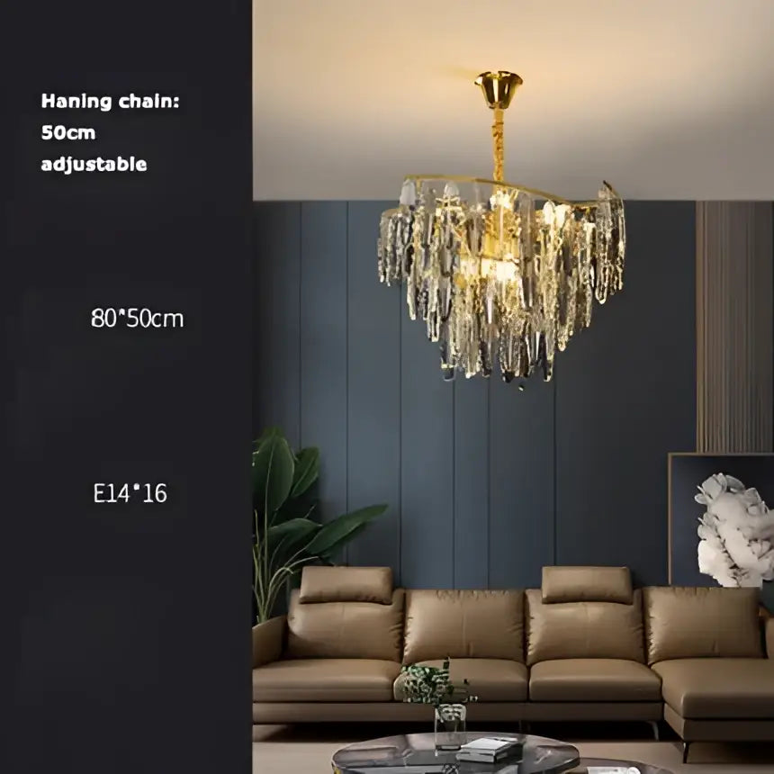 Gold-toned decorbites art deco led crystal chandelier with dangling droplets and decorative central frame for foyer lighting