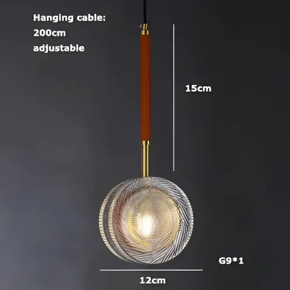 A modern glass pendant light by DecorBites Art Deco with circular textured design and warm golden glow, art deco LED style