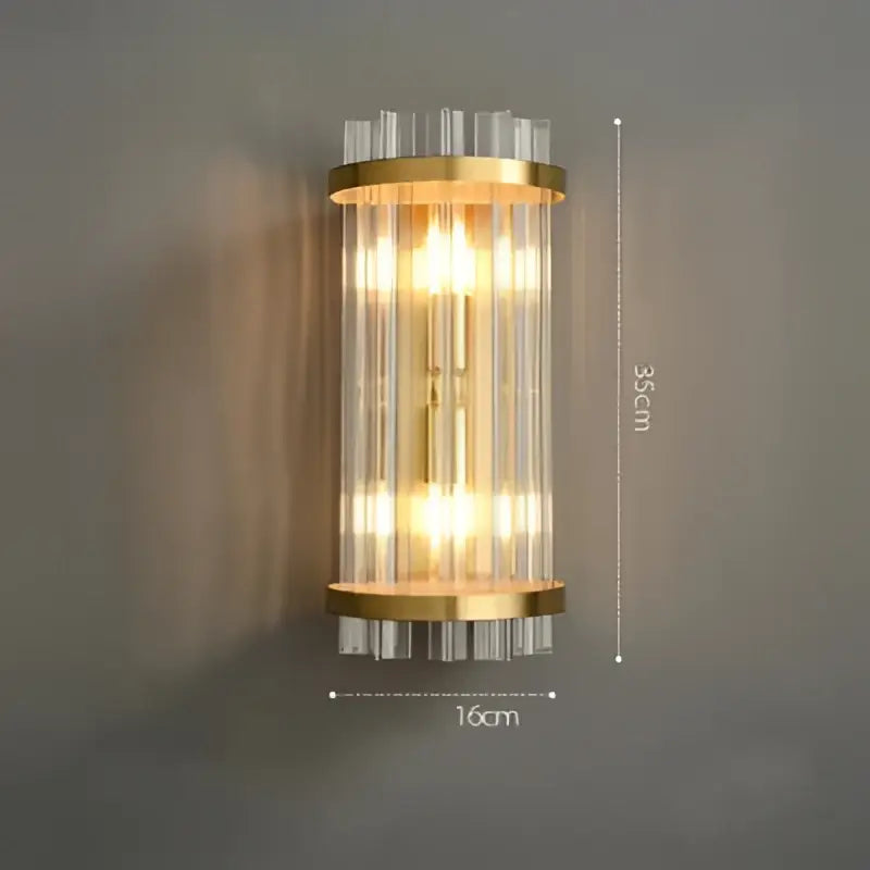 Gold-toned DecorBites Art Deco LED stainless steel wall sconce with vertical clear glass rods and warm glowing lights