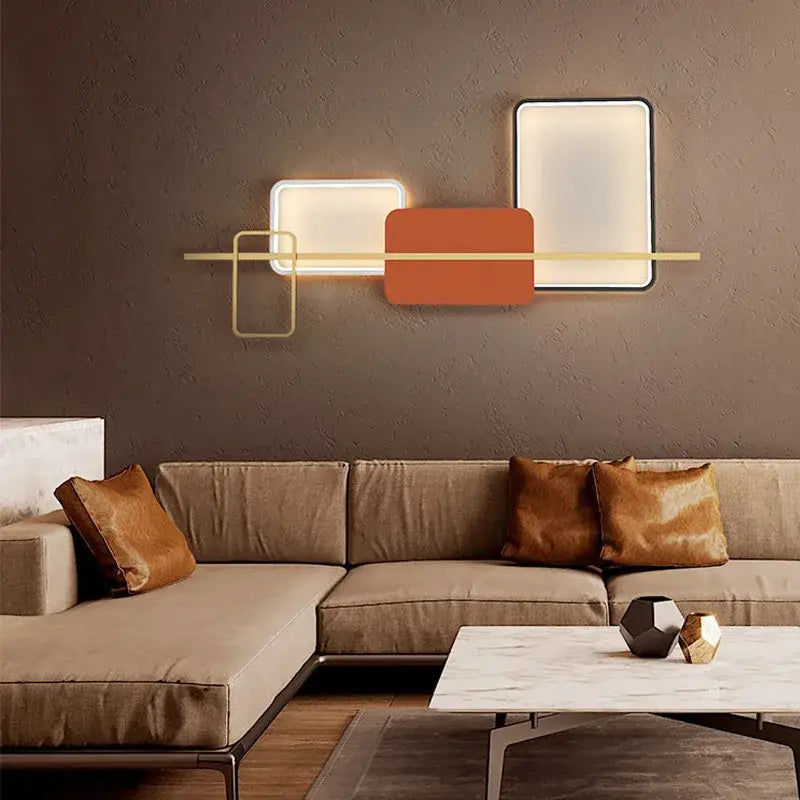Modern geometric decorbites art deco metal wall sconce with white and orange illuminated panels and gold bar accent