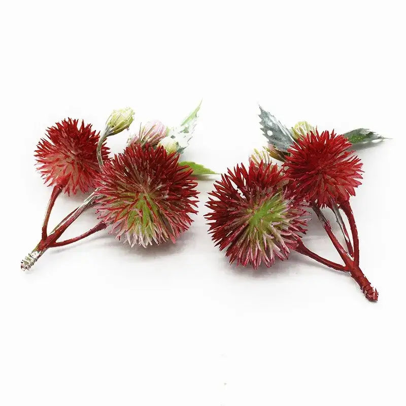 DecorBites™ artificial grass plants featuring red spiky flower boutonnieres with green accents and metallic stems