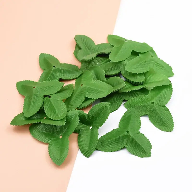 Decorbites artificial green silk roses featuring textured artificial green leaves with punched holes for DIY decor
