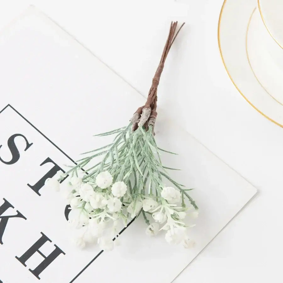 Decorbites artificial gypsophila plants featuring tiny white blossoms and sage green stems tied with rustic brown twine