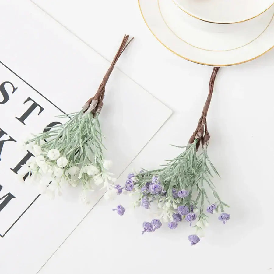 Two artificial gypsophila plants with light green stems and tiny white and purple blossoms for home decor and weddings