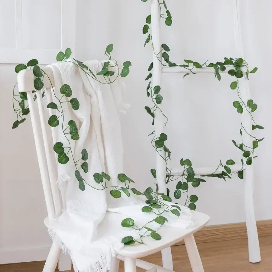Decorbites artificial hanging green silk ivy vine with round leaves draped over white chair and ladder for christmas decor