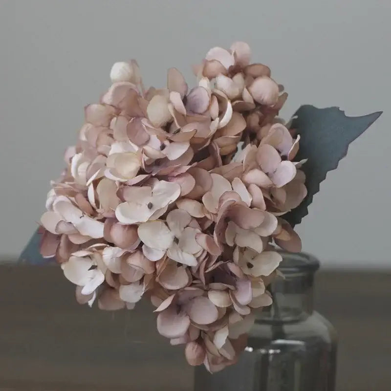 A delicate decorbites artificial hydrangea silk flower arrangement in soft blush cream tones with dark green leaf for wedding decor