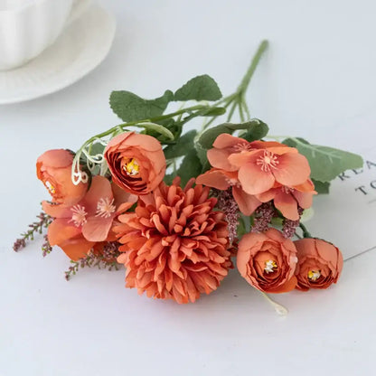 A cluster of decorbites artificial hydrangea tea orange flowers with green stems featuring ruffled petals and delicate centers
