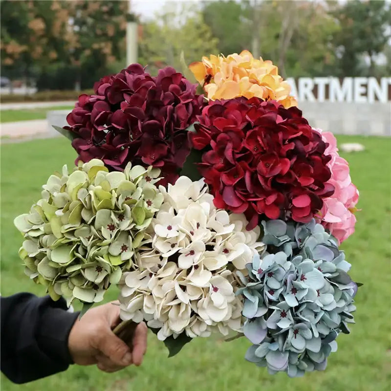 A vibrant decorbites™ artificial hydrangea wedding bouquet in burgundy pink white and blue green for indoor decoration