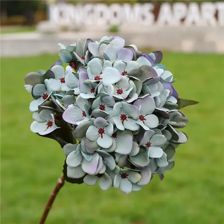 Decorbites artificial hydrangea wedding flowers with lavender and pale blue petals accented by deep red centers for indoor decor