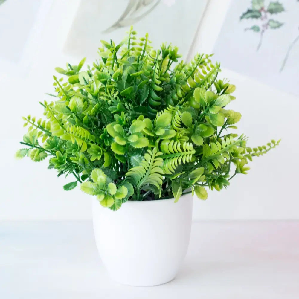Decorbites artificial mini plant featuring a lush green fern bush in a white ceramic pot for desktop bonsai decor