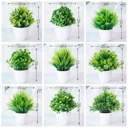 Set of nine decorbites artificial mini green plants in white ceramic pots with varying leaf textures and heights
