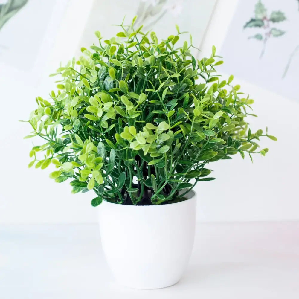 A lush green decorbites artificial mini plant bonsai with dense foliage in a white ceramic pot for desktop decor