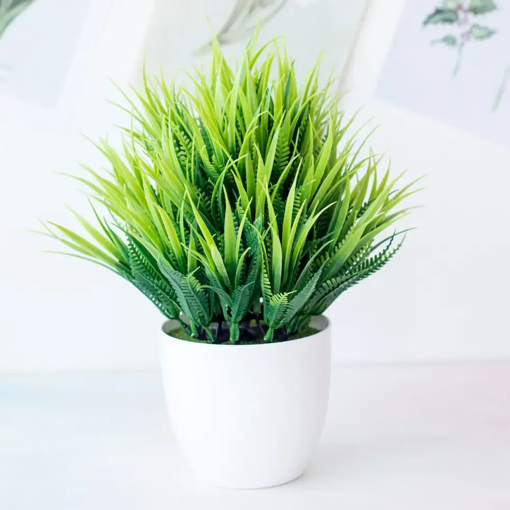 A vibrant green decorbites artificial mini plant bonsai with feathery fronds in a white ceramic pot for desktop decor