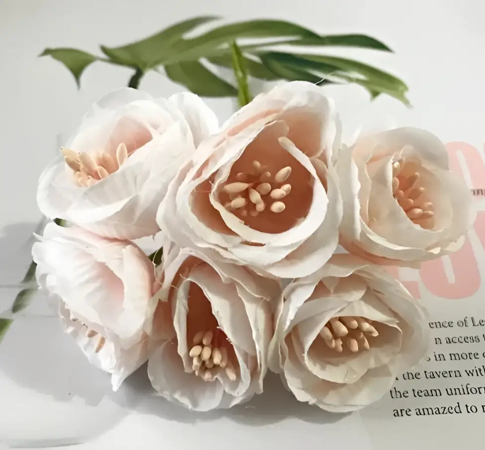 A cluster of pale pink decorbites artificial peony tea rose silk flowers with beige stamen centers for home and wedding decor