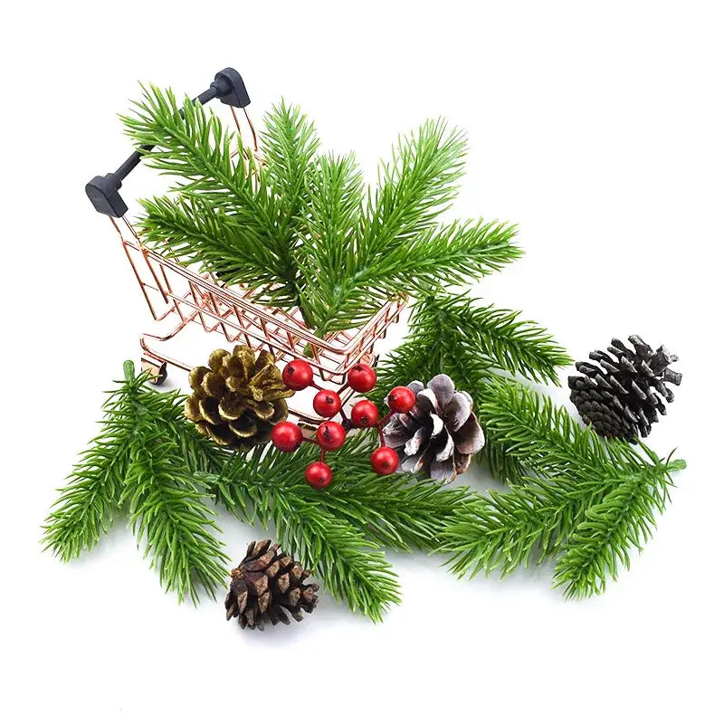 Rose gold miniature shopping cart filled with artificial green pine needle plants red berries and pinecones for christmas decor