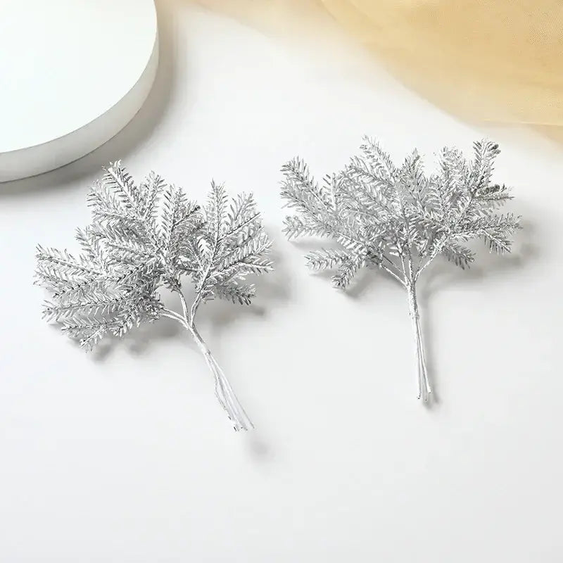 Decorbites™ artificial pine needles featuring silver metallic faux evergreen sprigs with intricate branching leaf designs