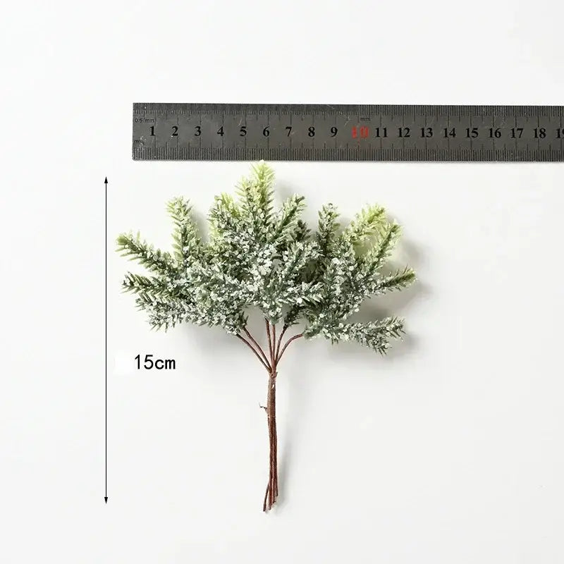 A 15cm decorbites artificial pine sprig with frosted green needles and brown stem for home decor and christmas garlands