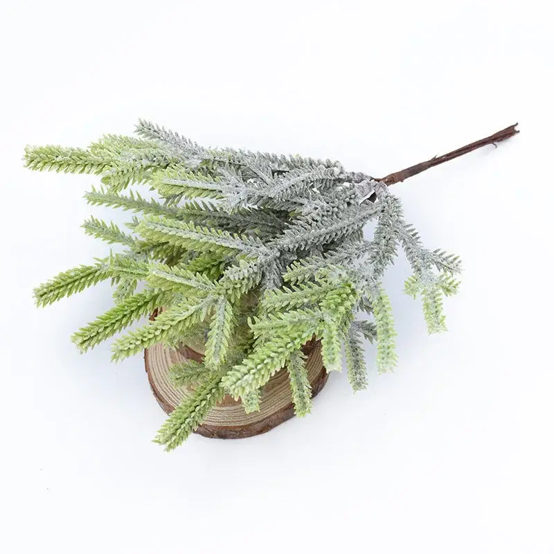 Decorbites artificial pine plants featuring faux evergreen branch with frosted tips and rustic wooden base for decoration