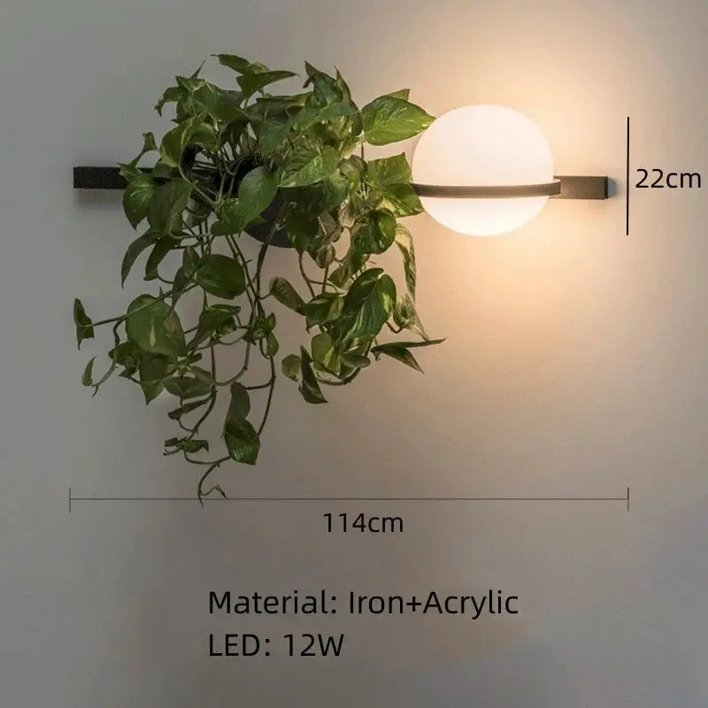 Modern black iron pendant light with spherical frosted globe and hanging green vine decorbites artificial plant pendant