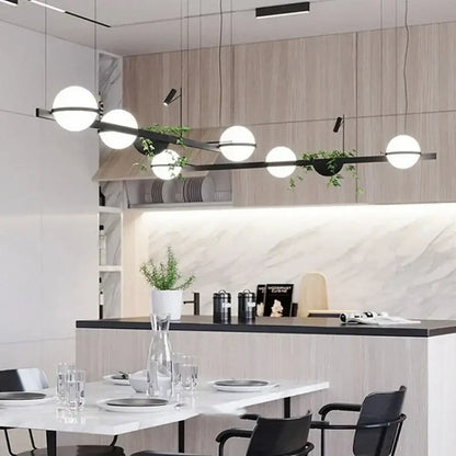 Modern black metal pendant light with spherical white glass bulbs and integrated green decorbites artificial plant planter