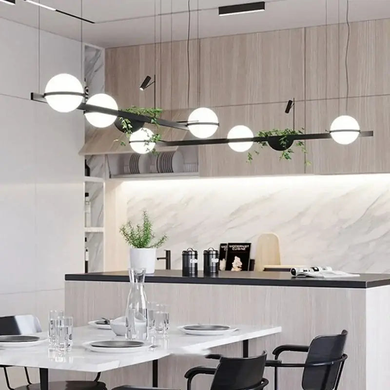 Modern black metal pendant light with spherical white glass bulbs and integrated green decorbites artificial plant planter