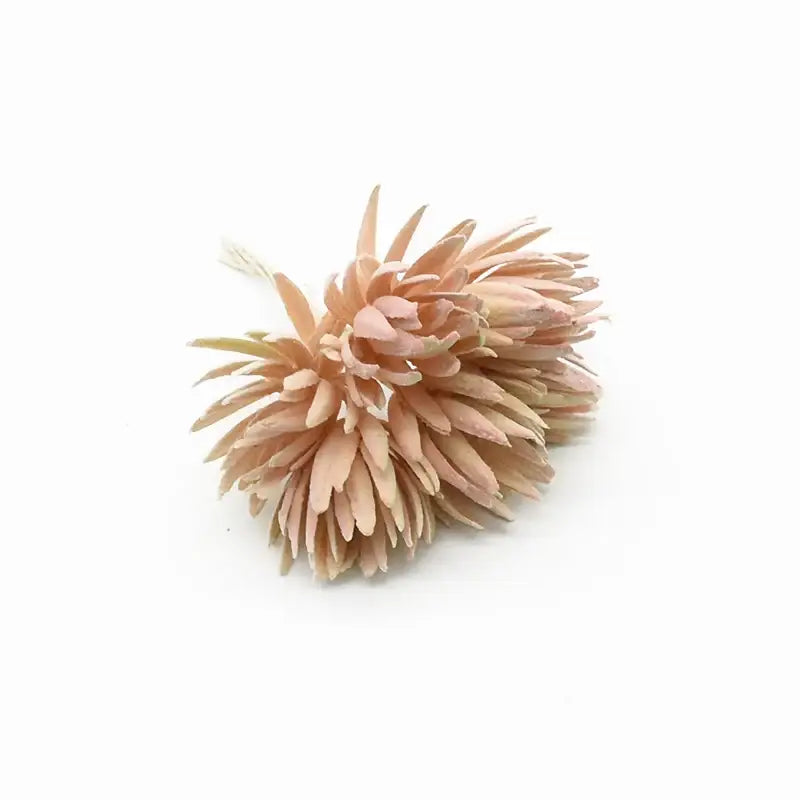 A delicate peach-colored fake flower with layered spiky petals from decorbites artificial plant for christmas decor