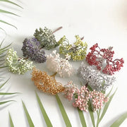A collection of decorbites artificial plants diy garland clusters in pastel and metallic hues mimicking dried plants textures