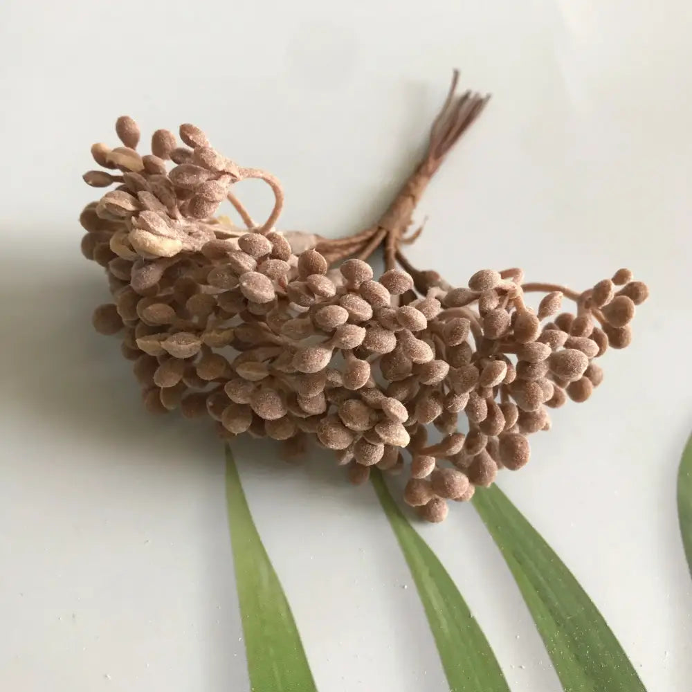 A cluster of brown faux seed pods with matte finish and bundled stems from decorbites artificial plants dried plants diy garland