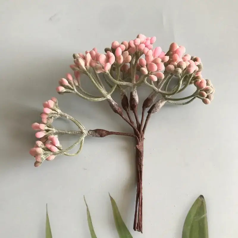 A delicate cluster of pink frosted artificial berries with brown stems from decorbites artificial plants diy dried plants collection