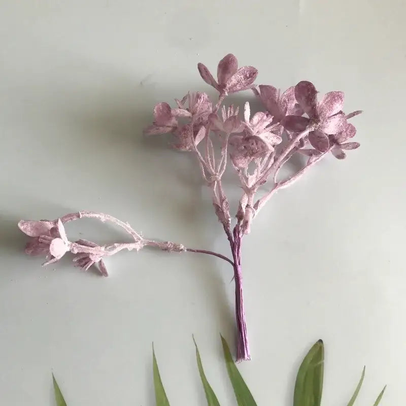 A delicate cluster of pink artificial plants with frosted textured finish and slender stems by decorbites artificial plants