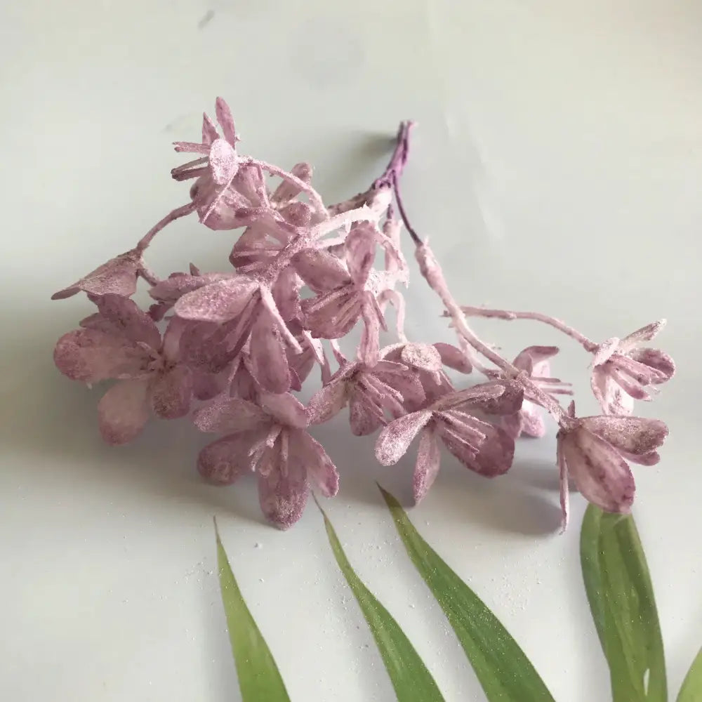 A delicate cluster of lavender artificial plants with glittery hydrangea blossoms from decorbites artificial plants collection
