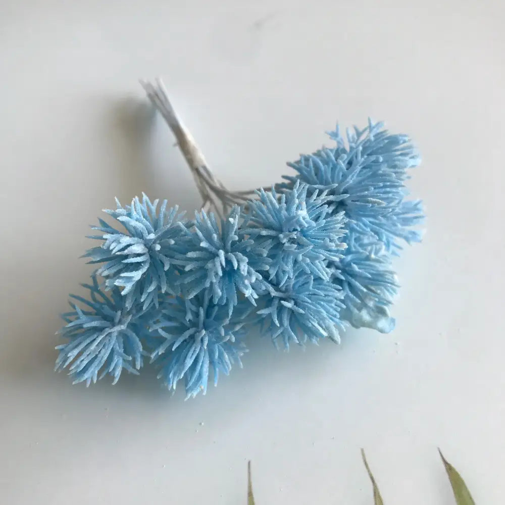 A cluster of light blue spiky fuzzy artificial plants from DecorBites artificial plants set for wedding and home decor