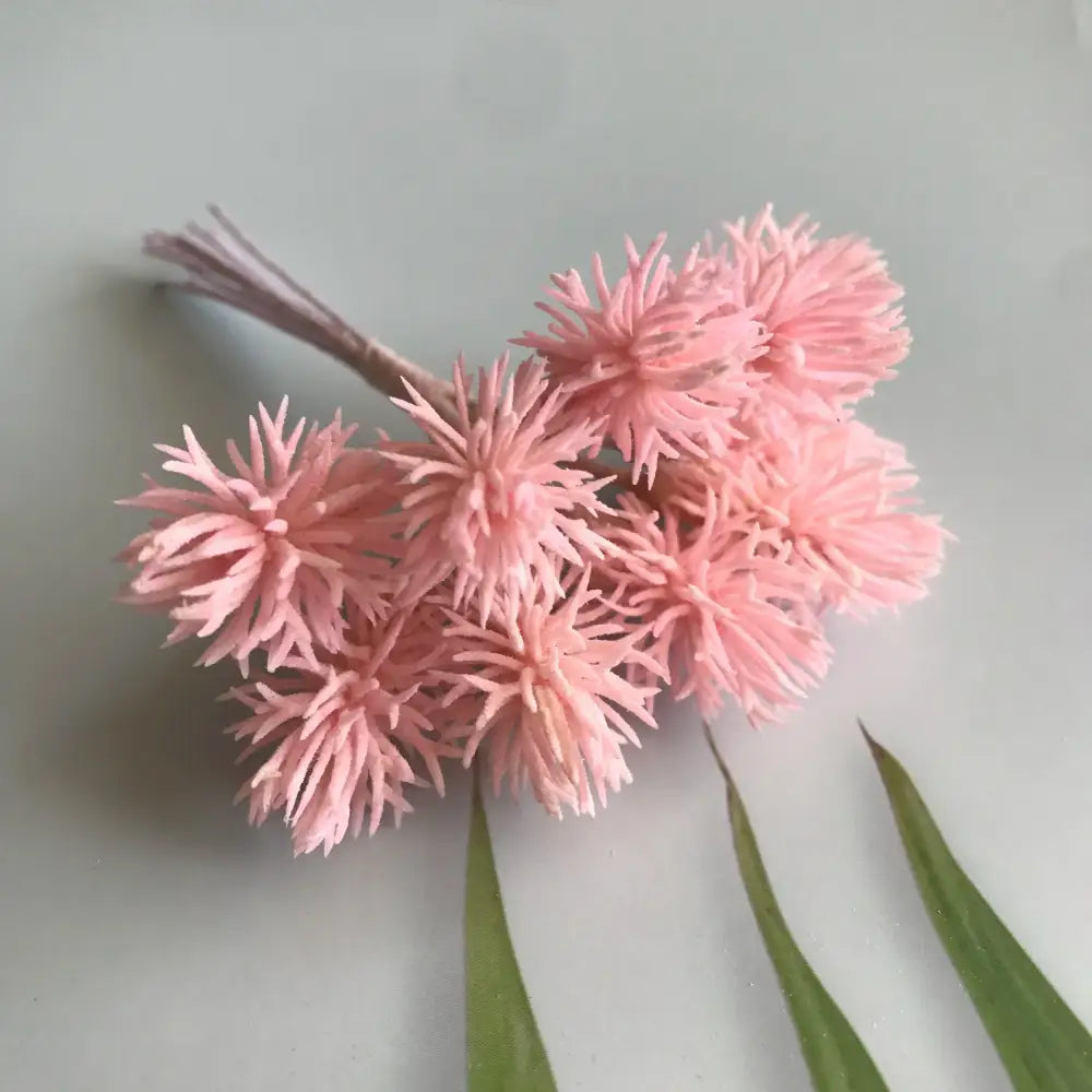 A cluster of delicate pink artificial plants with spiky petals and bundled stems from decorbites artificial plants set