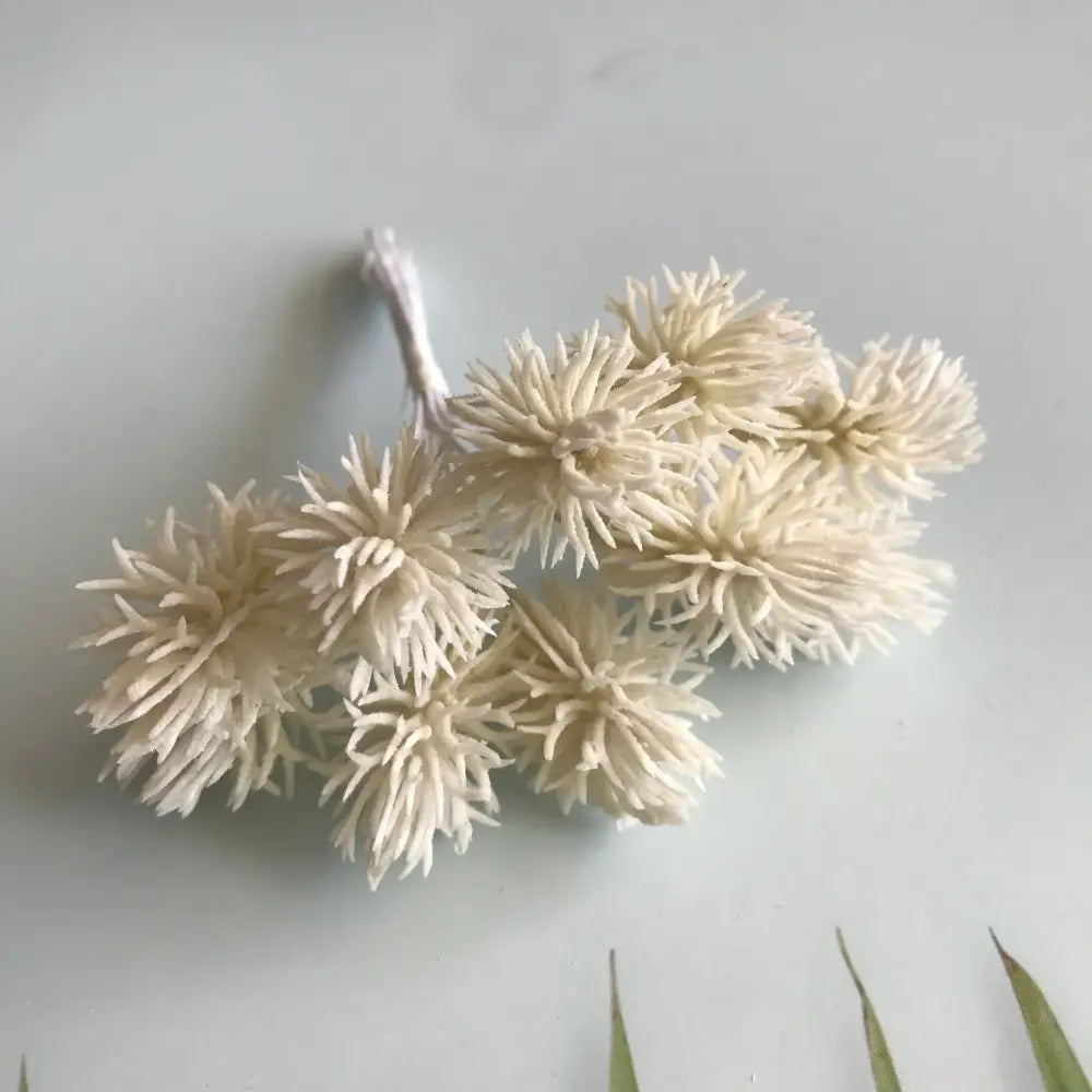 A cluster of cream-colored spiky fibrous decorbites artificial plants for wedding and home decor set of 6