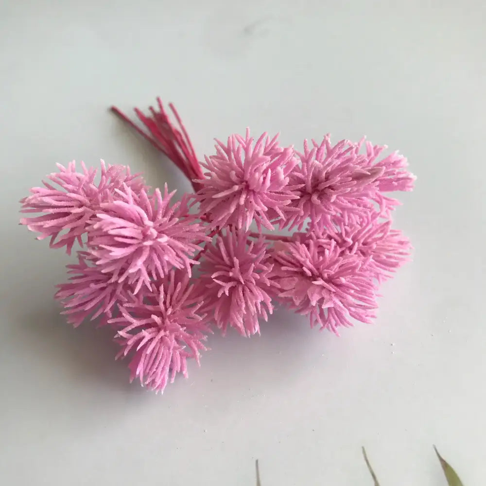 A cluster of pink spiky artificial plants with textured petals and thin stems from decorbites artificial plants set