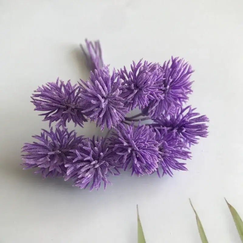A cluster of purple spiky petal artificial plants with thin stems from decorbites artificial plants set of 6