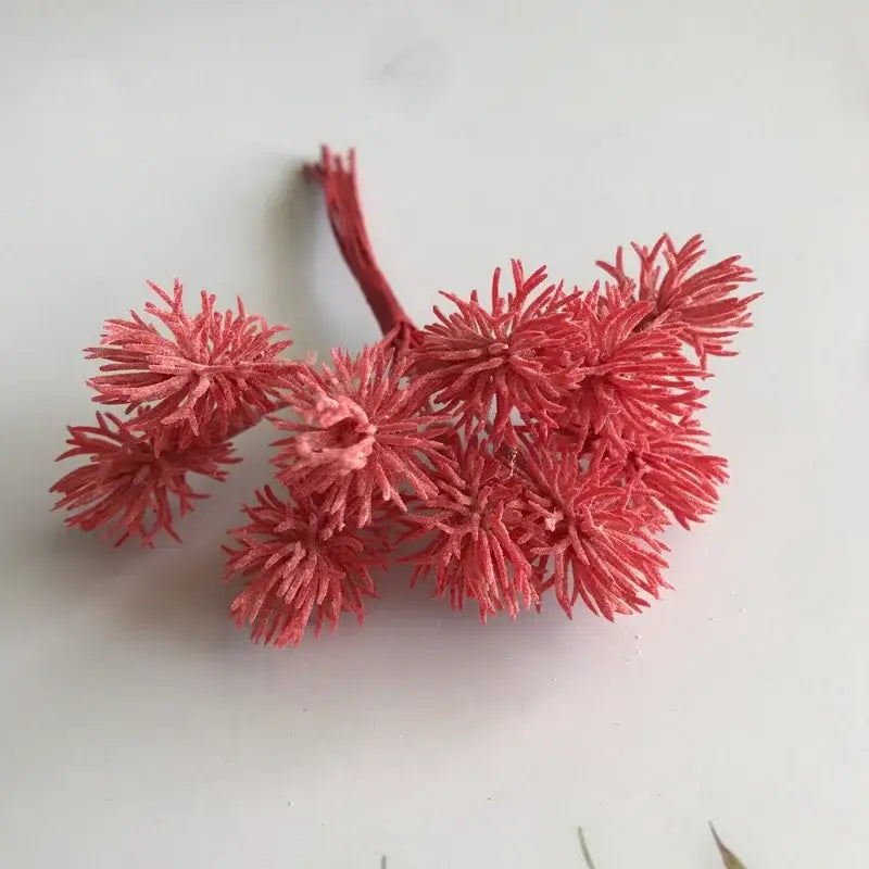 A cluster of coral-pink spiky artificial plants made of fibrous material from decorbites artificial plants set of 6